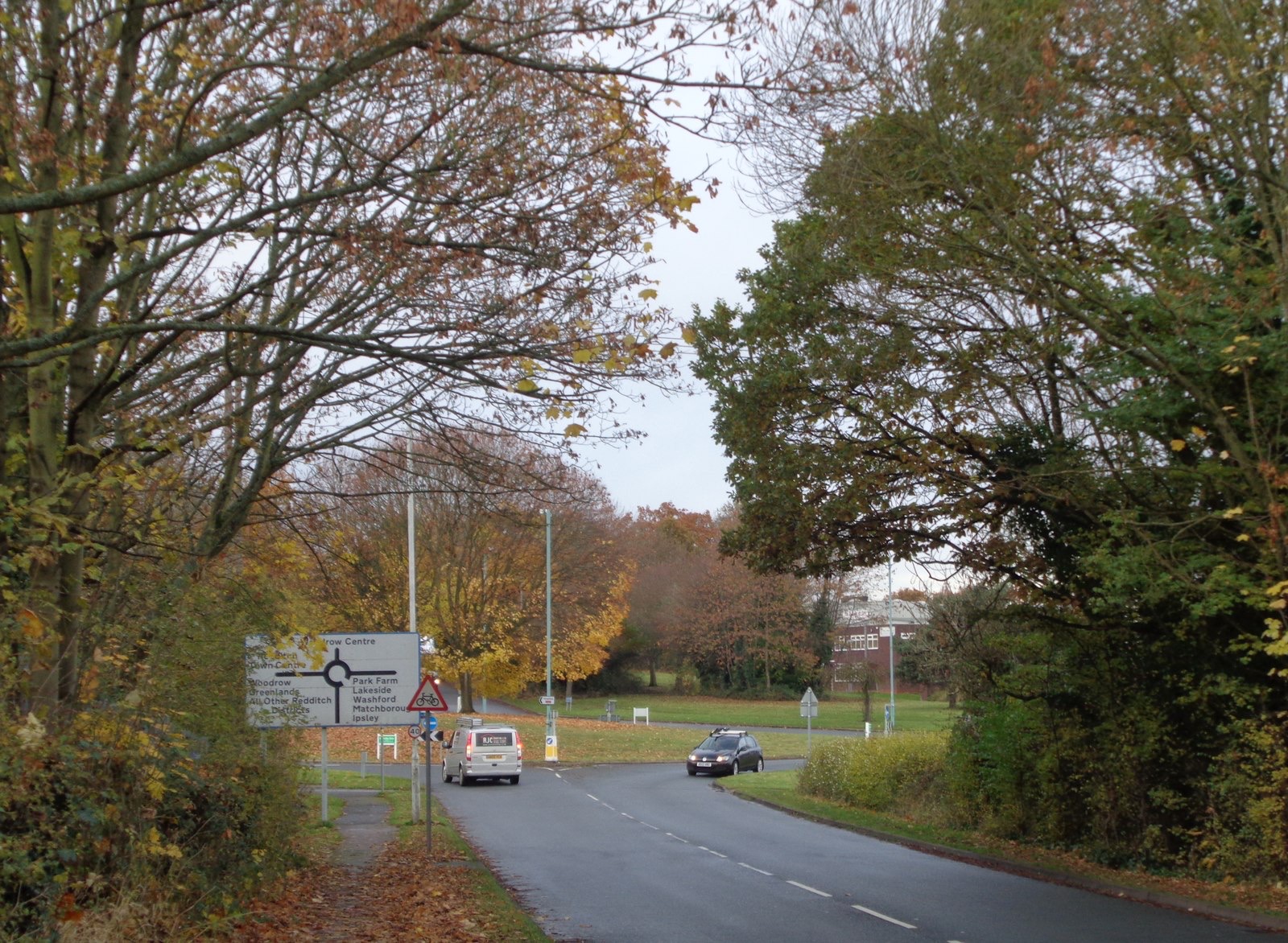 Autumn trees in orange and gold around the Studley Road island at Woodrow Drive